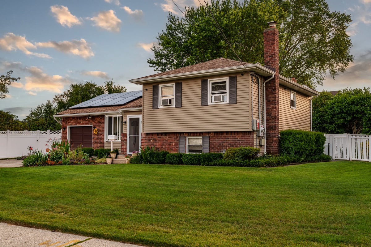 Middle income older home with natural light showing front of house, 1970s era