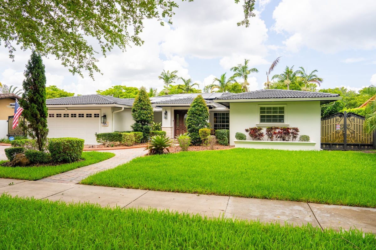 Bright middle class residential home in sunny Miami Lakes Florida, well-maintained with blue sky
