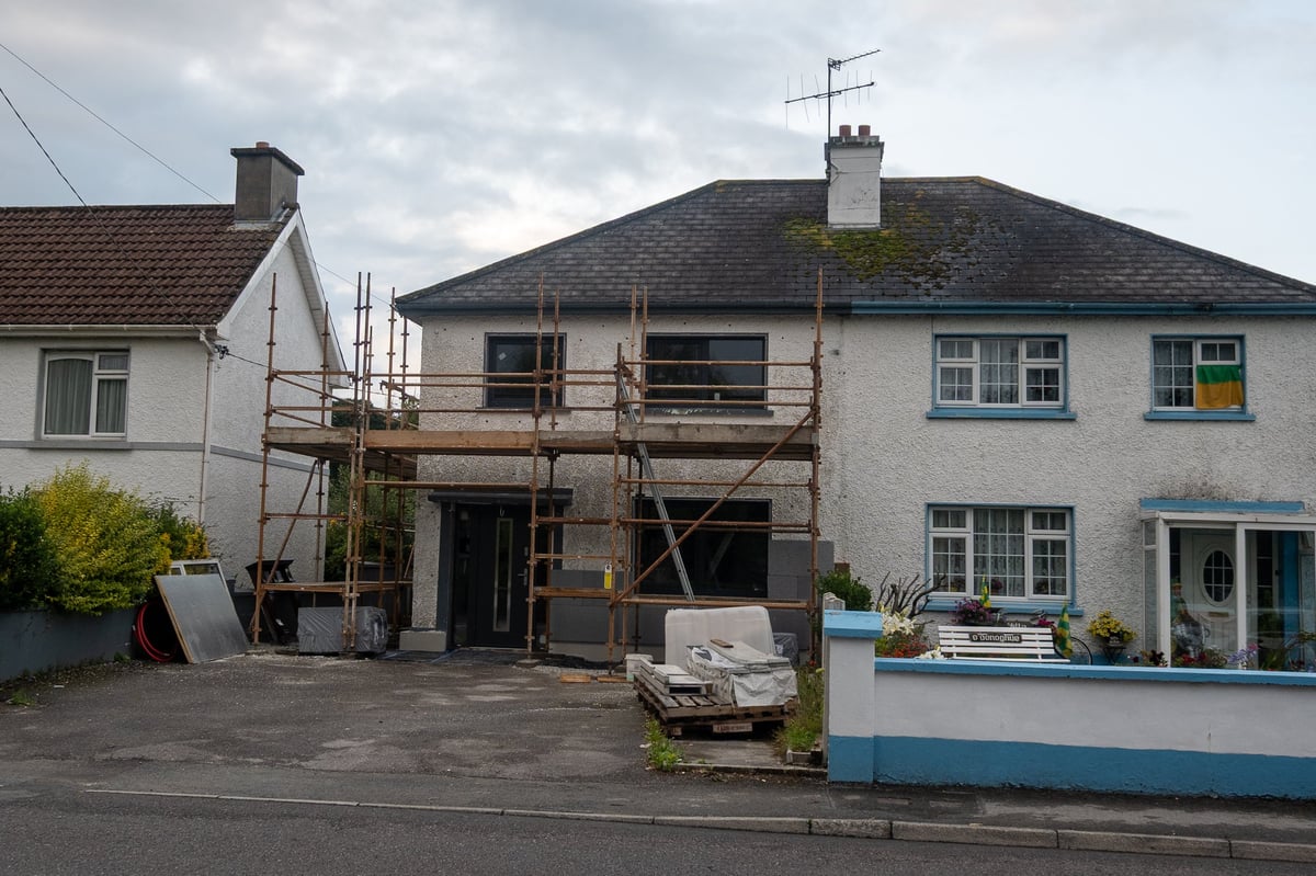 Home undergoing renovations with scaffolding, house needing major work