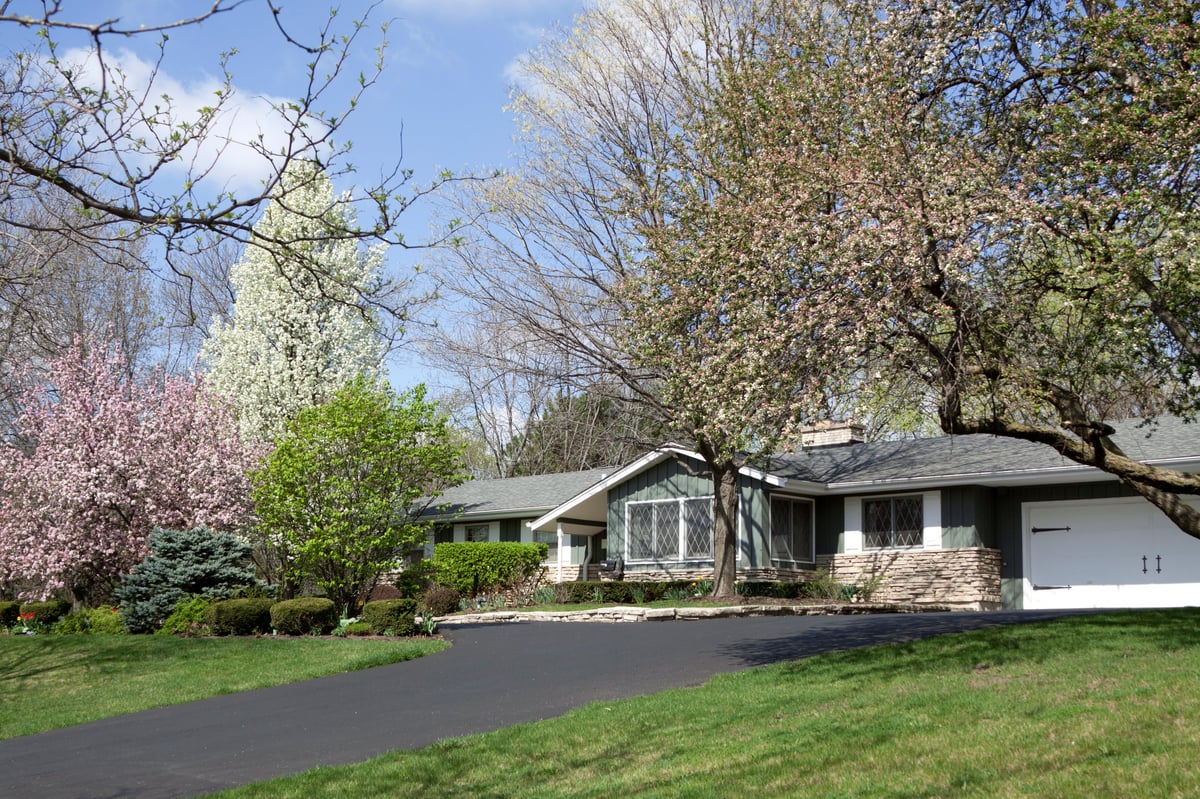 Older modest house with slightly overgrown yard, needs cosmetic updates and lawn care